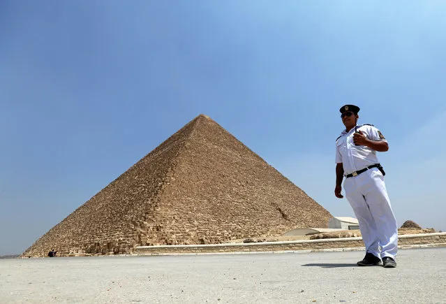 A policeman stands guard in front of the Pyramid of Khufu, the largest of the Great Pyramids of Giza, on the outskirts of Cairo, Egypt, August 31, 2016. (Photo by Mohamed Abd El Ghany/Reuters)