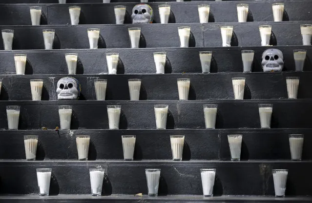 A Day of the Dead altar adorned with candles and skulls sits inside Senate in Mexico City, Saturday, October 31, 2020. Mexico’s Day of the Dead celebration won’t be the same in a year so marked by death after more than 90,000 people have died of COVID-19. (Photo by Ginnette Riquelme/AP Photo)