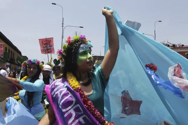 Environmental activists march during the “People's Climate March” in down town Lima, December 10, 2014. Thousands marched through Lima on Wednesday to protest against climate change as the United Nations climate summit, COP20, nears its final days. (Photo by Guadalupe Pardo/Reuters)