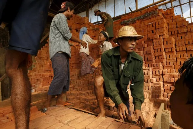 People work in a brick factory at the outskirts of Yangon November 4, 2015. (Photo by Jorge Silva/Reuters)