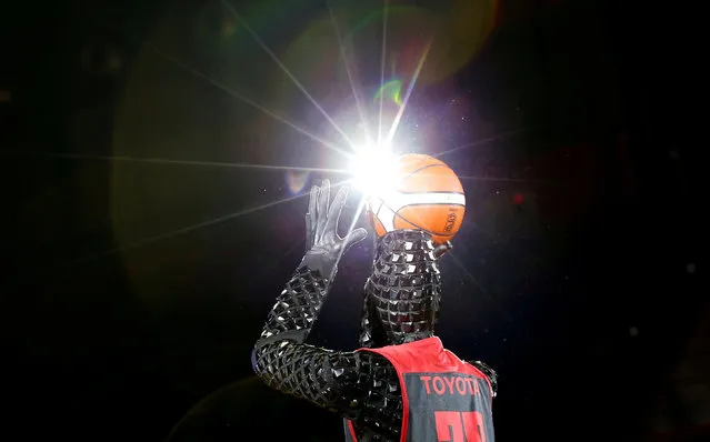 A basketball-playing robot called CUE, developed by Toyota engineers, shoots a free throw during a rehearsal for half-time show of Alvark Tokyo's basketball match in Tokyo, Japan March 28, 2018. (Photo by Toru Hanai/Reuters)