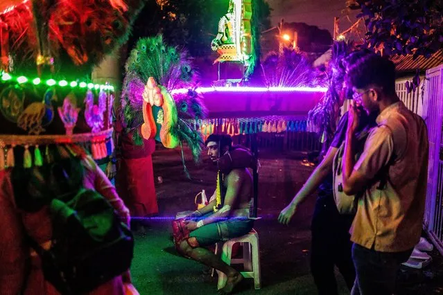 A Malaysian Hindu devotee carries a kavadi burden on his shoulders before he makes his way towards the Batu Caves temple to make offerings during Thaipusam, a festival celebrated mostly by the Tamil community in Kuala Lumpur, Malaysia on February 5, 2023. Devotees pray and make vows, which they fulfil by piercing parts of their body such as their cheeks, tongues and backs and carrying a kavadi on a 2.5-mile journey of faith. (Photo by Mohd Firdaus/NurPhoto/Rex Features/Shutterstock)