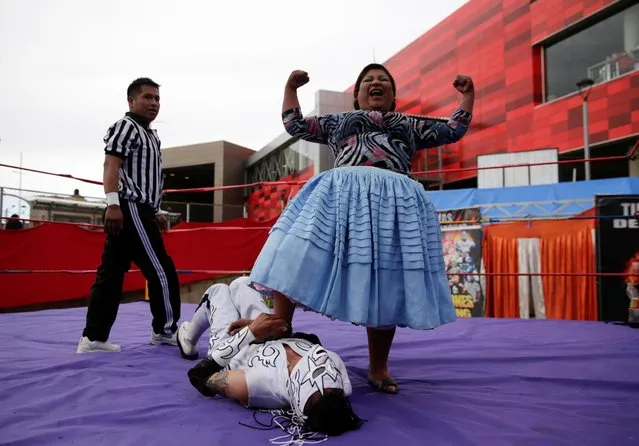 Silvana La Poderosa, a cholita wrestler, reacts after winning a fight during their return to the ring after the coronavirus disease (COVID-19) restrictions, in El Alto outskirts of La Paz, December 6, 2020. (Photo by David Mercado/Reuters)