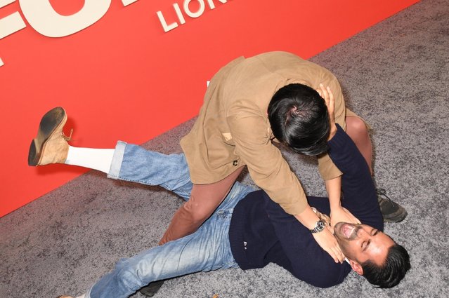 Ronny Chieng and Hasan Minaj have a play fight on the carpet of the “Good Fortune” New York special screening held at AMC Lincoln Square 13 on October 13, 2025 in New York, New York. (Photo by MediaPunch/Backgrid USA)