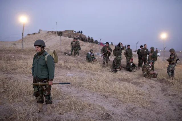 Kurdish Peshmerga forces gather prior to opening up a front against Islamic state in Nawaran, some 20 kilometers (13 miles) northeast of Mosul, Iraq, Thursday, October 20, 2016. Peshmerga are launching an offensive to take the villages on the Nawaran mountain, pulling closer to Mosul. (Photo by Marko Drobnjakovic/AP Photo)