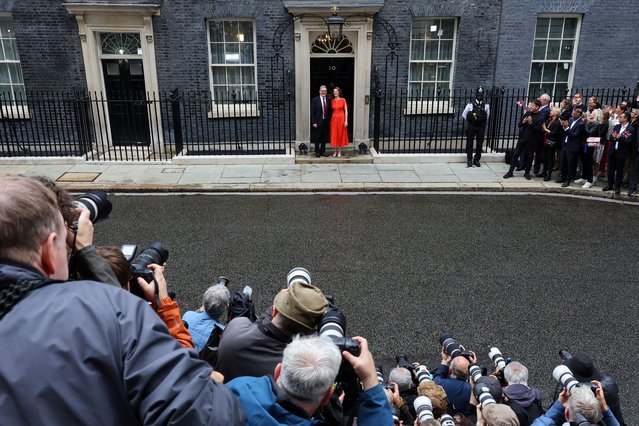 Photographers take pictures as British Prime Minister Keir Starmer and his wife Victoria Starmer stand outside Number 10 Downing Street, following the results of the election, in London, Britain, on July 5, 2024. (Photo by Toby Melville/Reuters)
