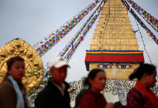 Devotees stand in a queue in front of the Boudhanath Stupa to offer butter lamps during the birth anniversary of Buddha, also known as Vesak Day, in Kathmandu, Nepal April 30, 2018. (Photo by Navesh Chitrakar/Reuters)