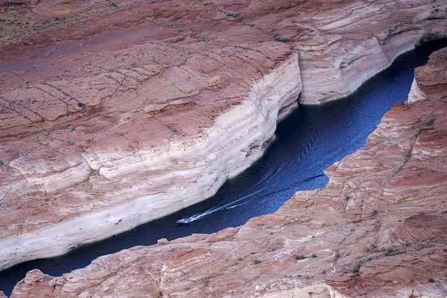A power boat moves through a canyon at Lake Powell near Page, Arizona, May 26, 2015 with the high water mark visible above it. (Photo by Rick Wilking/Reuters)