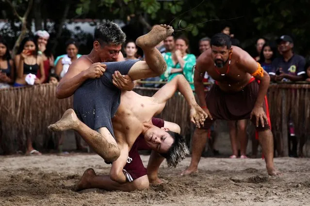 People wrestle during the Indigenous Games in Peruibe, Brazil on April 23, 2023. (Photo by Carla Carniel/Reuters)