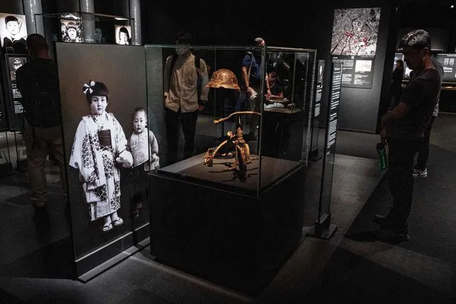 This photo taken on May 15, 2023 shows a tricycle (C) donated by Nobuo Tesutani – the father of a boy who died in the 1945 atomic bombing, on display at the Hiroshima Peace Memorial Museum in Hiroshima, just days ahead of the arrival of leaders for the G7 Leaders' Summit. G7 leaders meet in Hiroshima from May 19-21, looking to tighten the screws further on Russia over the Ukraine war and agree a united line on China's growing military and economic power. (Photo by Richard A. Brooks/AFP Photo)