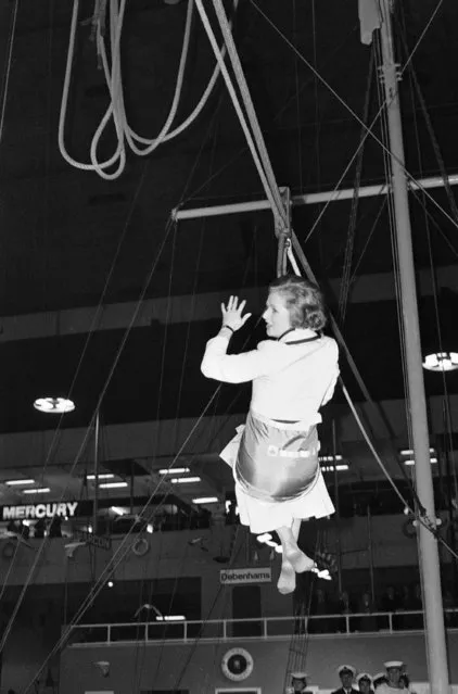 Not appearing her usual cool self, a shoeless Margaret Thatcher, Britain's Opposition leader, gets taken for a ride in a bosun's chair more usually used for transporting sailors between ships at sea at the 25th International Boat Show at London's Earls Court on Thursday, January 4, 1979. Mrs. Thatcher had earlier opened the show, which features the best in the boating world. (Photo by Lawrence Harris/AP Photo)