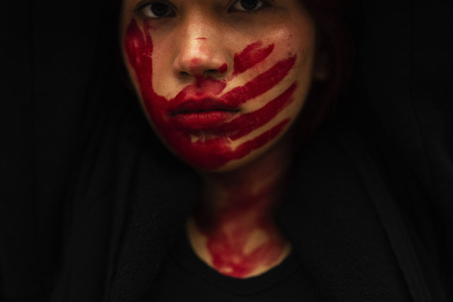 A woman with a painted face attends a protest against violence against women in Istanbul, Turkey, Saturday, October 12, 2024. (Photo by Francisco Seco/AP Photo)