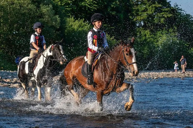 Riders ford the River Ettrick during the Selkirk Common Riding, a centuries-old tradition in the royal burgh of Selkirk in the Scottish Borders on Friday, June 16, 2023. (Photo by Jane Barlow/PA Images via Getty Images)