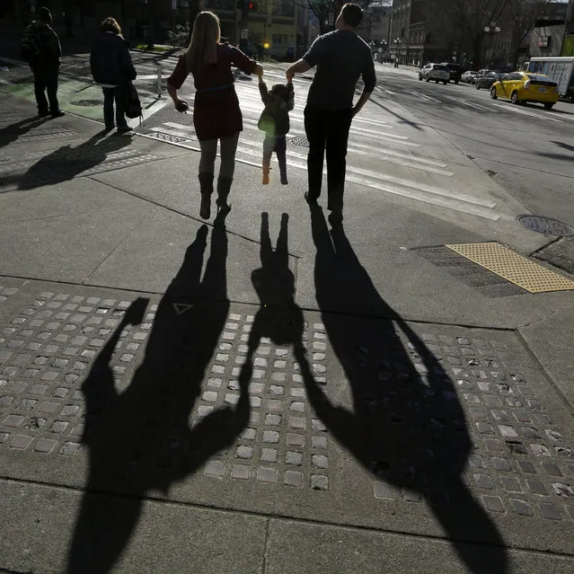 In this March 3, 2015 file photo, a couple holds up their 2-year-old daughter in Seattle. According to a study released on Thursday, April 16, 2015, for U.S. mothers, the typical time between having babies is about 2 1/2 years, according to the first government study of its kind on the subject. (Photo by Ted S. Warren/AP Photo)