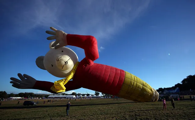 A hot air balloon in the shape of children's comic Rupert Bear is seen tethered before the launch of the Bristol International Balloon Fiesta in south west England, Britain, August 9, 2018. (Photo by Hannah McKay/Reuters)