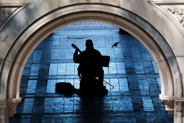 A man plays the guitar in a pavilion in Central Park on May 06, 2021 in New York City. As New York City begins to re-opens following pandemic lockdowns, thousands are flocking to city parks, restaurants and cultural events. (Photo by Spencer Platt/Getty Images)