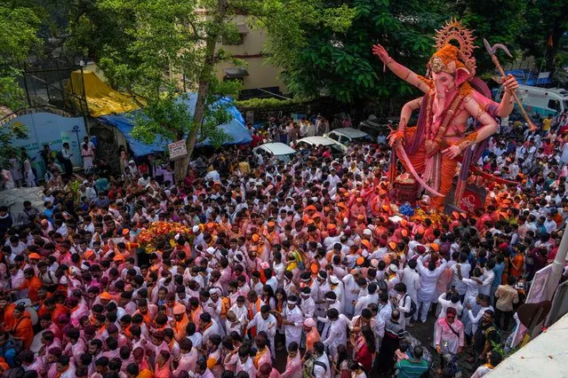An idol of elephant-headed Hindu god Ganesha is taken for immersion on the final day of the ten-day long Ganesh Chaturthi festival in Mumbai, India, Thursday, September 28, 2023. The festival is a celebration of the birth of Ganesha, the Hindu god of wisdom, prosperity and good fortune. (Photo by Rafiq Maqbool/AP Photo)