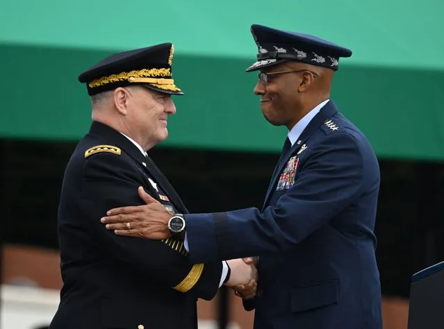 Retiring Chairman of the Joints Chiefs of Staff, Army General Mark Milley (L), greets incoming Chairman, Air Force General Charles Brown, during the Armed Forces Farewell Tribute in honor of Milley, at Joint Base Myer-Henderson Hall in Arlington, Virginia, on September 29, 2023. (Photo by Saul Loeb/AFP Photo)