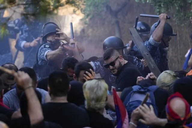 Policeman sprays Lebanese Armenian protesters outside the Azerbaijani embassy in Beirut, Lebanon, on Thursday, September 28, 2023. (Photo by Hussein Malla/AP Photo)