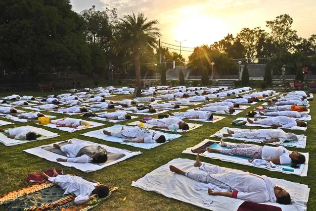 People take part in a yoga session at a park in Amritsar on June 21, 2021, to mark International Yoga Day. (Photo by Narinder Nanu/AFP Photo)
