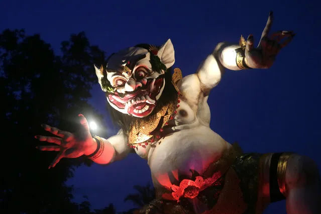 A view of one of the giant effigies in the form of devil, locally named as “Ogoh-ogoh” carried by Balinese during a parade before the Nyepi Day, the Balinese Day of Silence, that marks Balinese Hindu New Year in Gianyar, Bali, Indonesia, March 19, 2015. (Photo by Made Nagi/EPA)