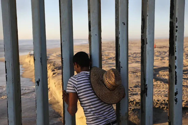 A man looks through the U.S.-Mexico border fence into the United States on September 25, 2016 in Tijuana, Mexico. Friendship Park on the border is one of the few places on the 2,000-mile border where separated families are allowed to meet. (Photo by John Moore/Getty Images)