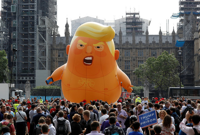 Demonstrators fly a blimp portraying U.S. President Donald Trump in Parliament Square, during the visit by Trump and first lady Melania Trump in London, Britain July 13, 2018. (Photo by Peter Nicholls/Reuters)