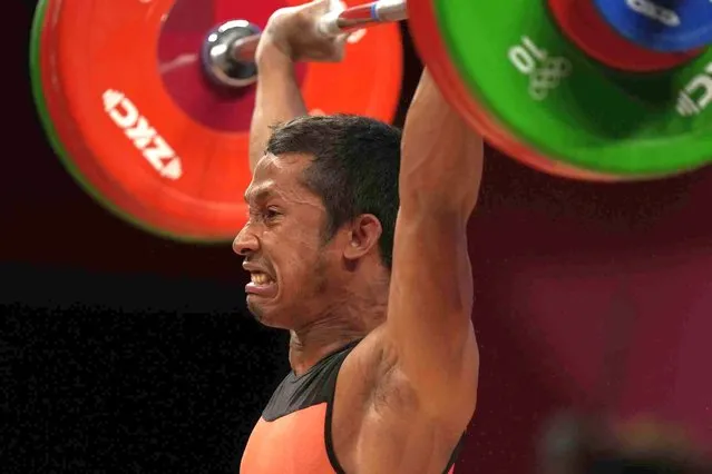 Eric Herman Andriantsitohaina of Madagascar competes in the men's 61kg weightlifting event, at the 2020 Summer Olympics, Sunday, July 25, 2021, in Tokyo, Japan. (Photo by Luca Bruno/AP Photo)
