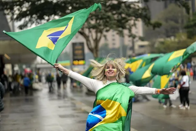 A supporter of Brazilian President Jair Bolsonaro, who is running for a second term, attends a demonstration to celebrate the bicentennial of the country's independence in Sao Paulo, Brazil, Wednesday, September 7, 2022. (Photo by Andre Penner/AP Photo)