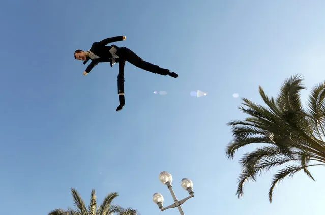 A puppet depicting French President Emmanuel Macron is tossed into the air by members of the “yellow vest” movement during a demonstration in Nice, France, January 12, 2019. (Photo by Eric Gaillard/Reuters)