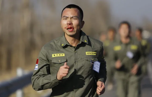 Blood drips from a student's nose as he takes part in a long-distance run during Tianjiao Special Guard/Security Consultant training on the outskirts of Beijing December 1, 2013. (Photo by Jason Lee/Reuters)