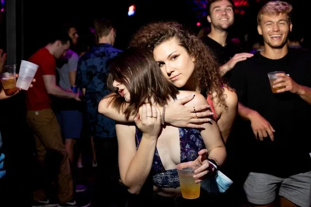 People dance after showing their coronavirus disease (COVID-19) vaccination certificate before entering the nightclub “Concourse Dance Bar”, in Philadelphia, Pennsylvania, U.S., August 14, 2021. (Photo by Hannah Beier/Reuters)