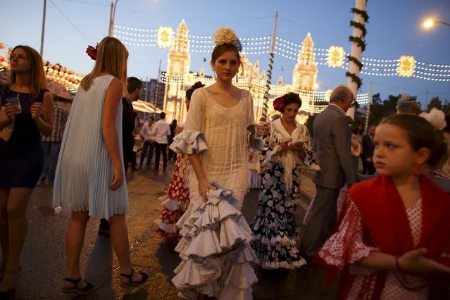 People walk during the traditional Feria de Abril (April fair) in the Andalusian capital of Seville, southern Spain, April 21, 2015. (Photo by Marcelo del Pozo/Reuters)