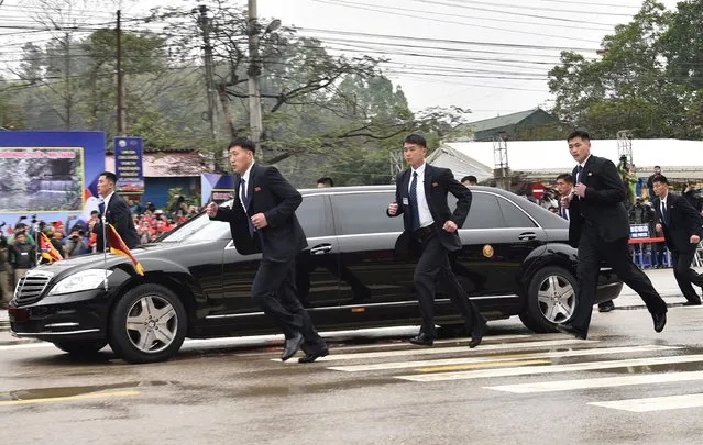 North Korean bodyguards run along a limousine transporting Kim Jong Un upon his arrival in Dong Dang, Vietnam, February 26, 2019. (Photo by Reuters/Stringer)