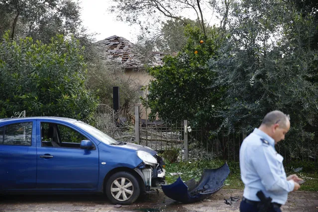 Damage to a house hit by a rocket is seen in Mishmeret, central Israel, Monday, March 25, 2019. An early morning rocket from the Gaza Strip struck a house in central Israel on Monday, wounding several people, an Israeli rescue service said, in an eruption of violence that could set off another round of violence shortly before the Israeli election. (Photo by Ariel Schalit/AP Photo)