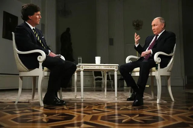In this pool photograph distributed by Russian state agency Sputnik, Russia's President Vladimir Putin gives an interview to US talk show host Tucker Carlson at the Kremlin in Moscow on February 6, 2024. (Photo by Gavriil Grigorov/Pool via AFP Photo)