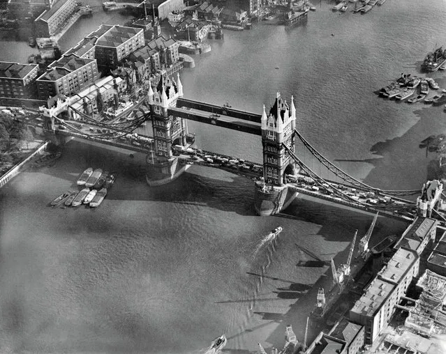 What at first glance stands out as a stunning view of one of London's most recognisable structures becomes more intriguing on closer examination. Here, Tower Bridge is the site of a chaotic logjam of traffic – caused, perhaps, by what seems to be an accident right at the
centre of its span