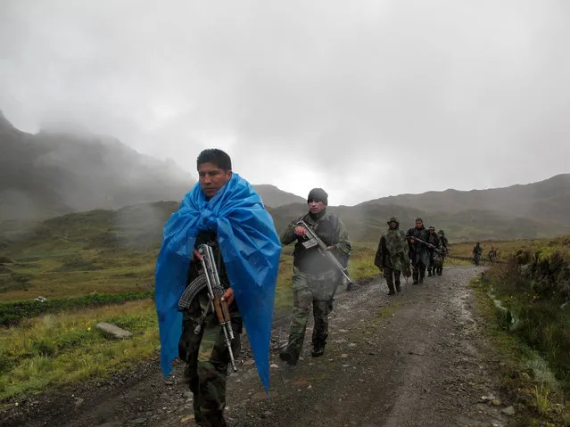 In this February 28, 2015 photo, a patrol of elite DIRANDRO counternarcotics police walks through a puna or highland plane in Husnay, Peru, after an unsuccessful mission to try to arrest drug-toting backpackers coming from the world's No. 1 cocaine-producing region. Its commander, Maj. Juan Tardio, said the unit spotted 15 backpackers less then a mile away early that morning but the smugglers were too far away to capture. His patrol had good intelligence, he said, but chose the wrong path of three options. (Photo by Rodrigo Abd/AP Photo)