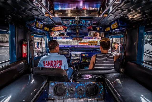 33-year old chauffeur John Paul has driven a Patok jeepney for seven years. He shares the daily rides with a friend who helps by taking the fares. (Photo by Claudio Sieber/Barcroft Media)