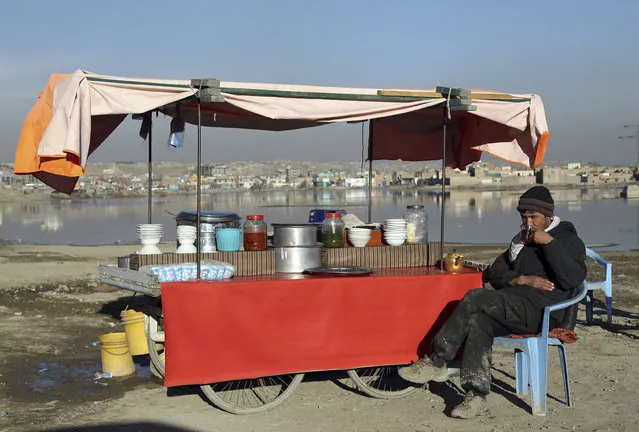 In this January 28, 2019 file photo, an Afghan street vendor waits for customers on the outskirts of Kabul, Afghanistan. In a Thursday, March 28, 2019 report the Special Inspector General for Afghan Reconstruction, a U.S. watchdog, said that Afghanistan will remain dependent on international donors and foreign help even after a peace deal with the Taliban is reached. The report identified main high-risk areas including the sluggish economy. (Photo by Rahmat Gul/AP Photo)