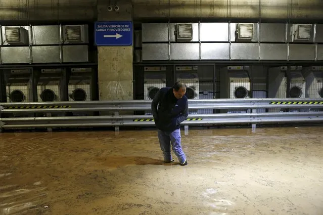 A man is seen inside an underground flooded parking in Santiago, April 17, 2016. (Photo by Ivan Alvarado/Reuters)