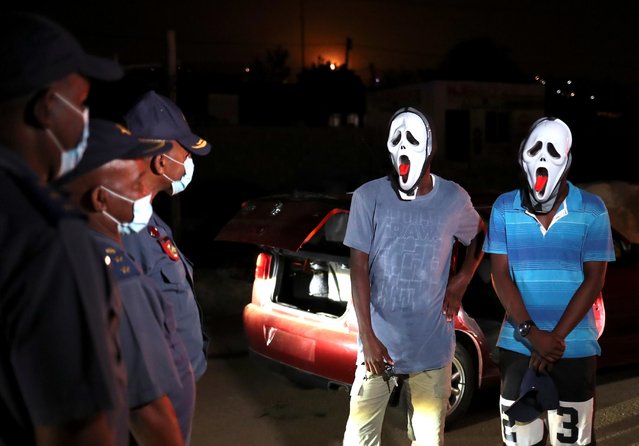 Police officers stop men wearing masks during a patrol as a nighttime curfew is reimposed amid a nationwide coronavirus disease (COVID-19) lockdown, in Pretoria, South Africa, January 9, 2021. (Photo by Siphiwe Sibeko/Reuters)