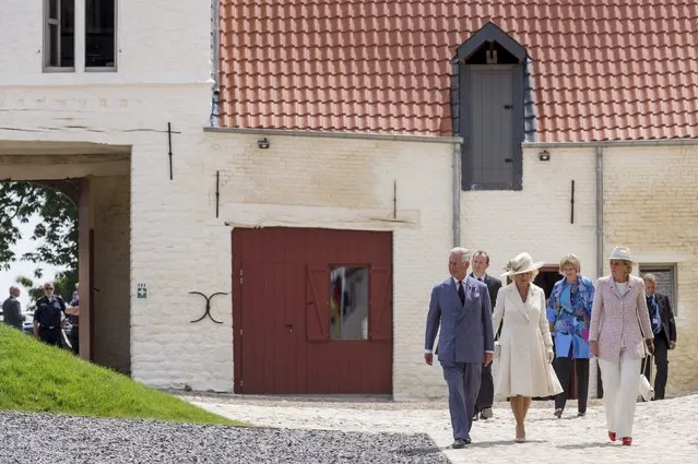 Britain's Prince Charles and Camilla, the Duchess of Cornwall, walk with Belgium's Princess Astrid (R) during a ceremony for the opening of the Hougoumont farm as part of the bicentennial celebrations for the Battle of Waterloo, near Waterloo, Belgium June 17, 2015. The commemorations for the 200th anniversary of the Battle of Waterloo will take place in Belgium on June 19 and 20. REUTERS/Geert Vanden Wijngaert/Pool