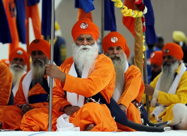Sikh marchers sit after a Khalsa Day parade marking Vaisakhi in front of city hall in Toronto, Canada April 24, 2016. (Photo by Chris Helgren/Reuters)