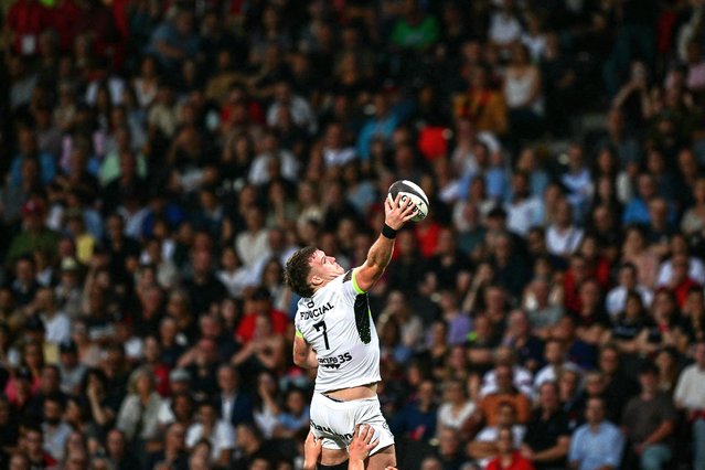 Toulouse's Irish lock Joshua Brennan (C) is lifted into the air to catch the ball from a Toulouse lineout during the French Top14 rugby union match between Lyon Olympique Universitaire Rugby and Stade Toulousain Rugby (Toulouse) at the Gerland Stadium in Lyon, central-eastern France, on June 8, 2024. (Photo by Olivier Chassignole/AFP Photo)