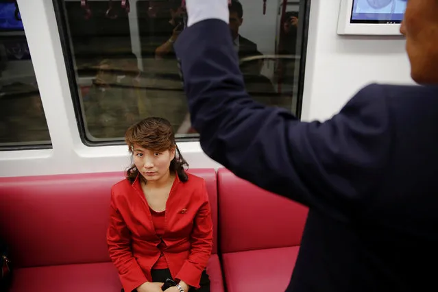 A passenger wearing red travels on a recently introduced new train during a government organised visit to the subway for foreign reporters in Pyongyang, North Korea May 7, 2016. (Photo by Damir Sagolj/Reuters)