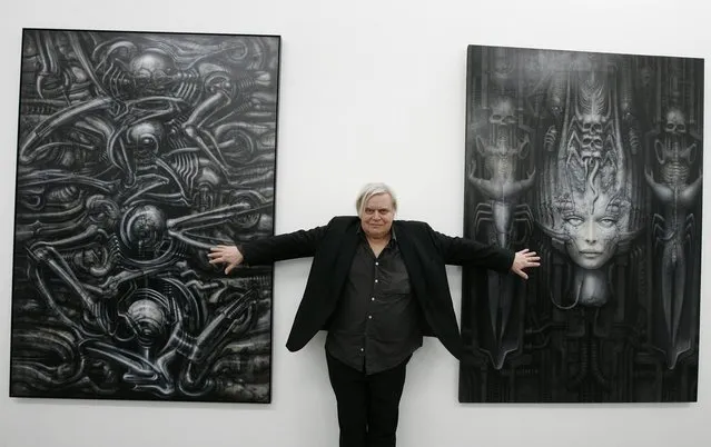 In this June 29, 2007 file picture  Swiss artist H.R. Giger  poses with two of his works at the art museum in Chur, Switzerland.  H.R. Giger, who designed the creature in Ridley Scott's sci-fi horror classic “Alien”, has died at age 74 from injuries suffered in a fall. Sandra Mivelaz, administrator of the H.R. Giger museum in Chateau St. Germain told The Associated Press Tuesday May 13, 2014  that Giger had died in a hospital the day before.  Giger  received a 1979 Academy Award for special effects in “Alen”. (Photo by Arno Balzarini/AP Photo/Keystone)