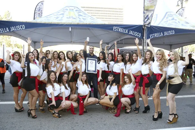 Joel Paulino, Senior Brand Manager Estrella Jalisco, celebrates the new Guinness Word Record for the largest game of Loteria during Fiesta Broadway with Estrella Jalisco on Sun., April 30, 2017, in Los Angeles. (Photo by Casey Rodgers/Invision for Estrella Jalisco/AP Images)