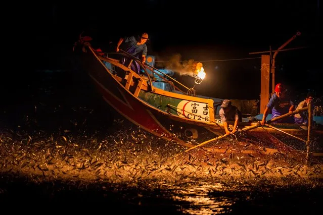 Fishermen use fire to attract fish on a traditional sulfuric fire fishing" boat, on August 20, 2021 in New Taipei City, Taiwan. Taiwan used to have 300 boats using the traditional fire fishing method but now only one boat remains. (Photo by Billy H.C. Kwok/Getty Images)