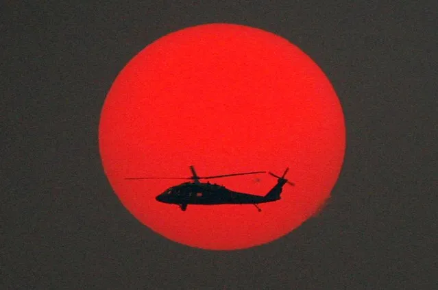 A U.S. Army Sikorsky UH-60 Black Hawk helicopter patrols during sunset over Baghdad, Iraq in a December 13, 2006 file photo. (Photo by Nikola Solic/Reuters)